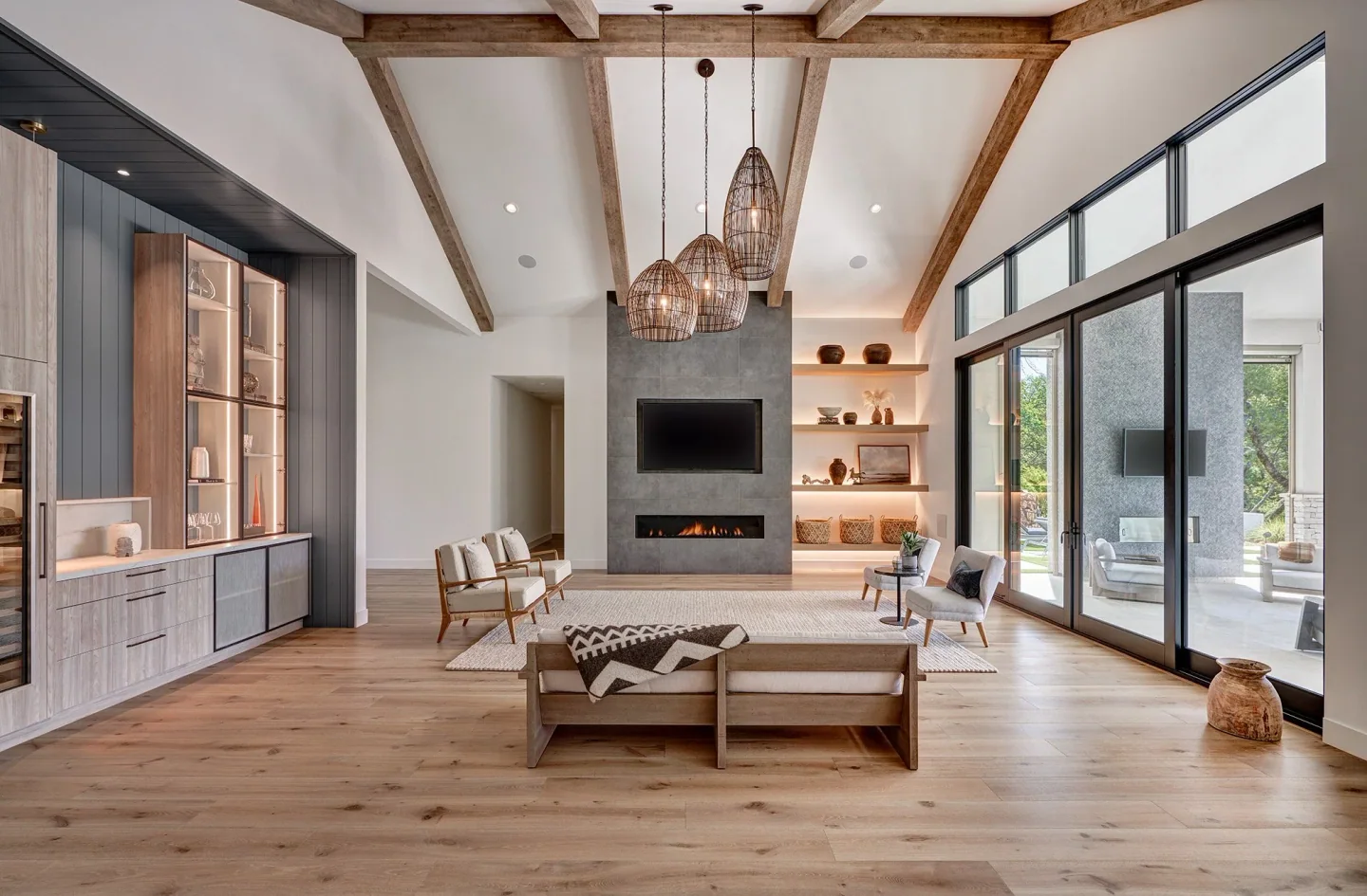 Timber beams and built-in shelving frame a light-filled living room at California Dream