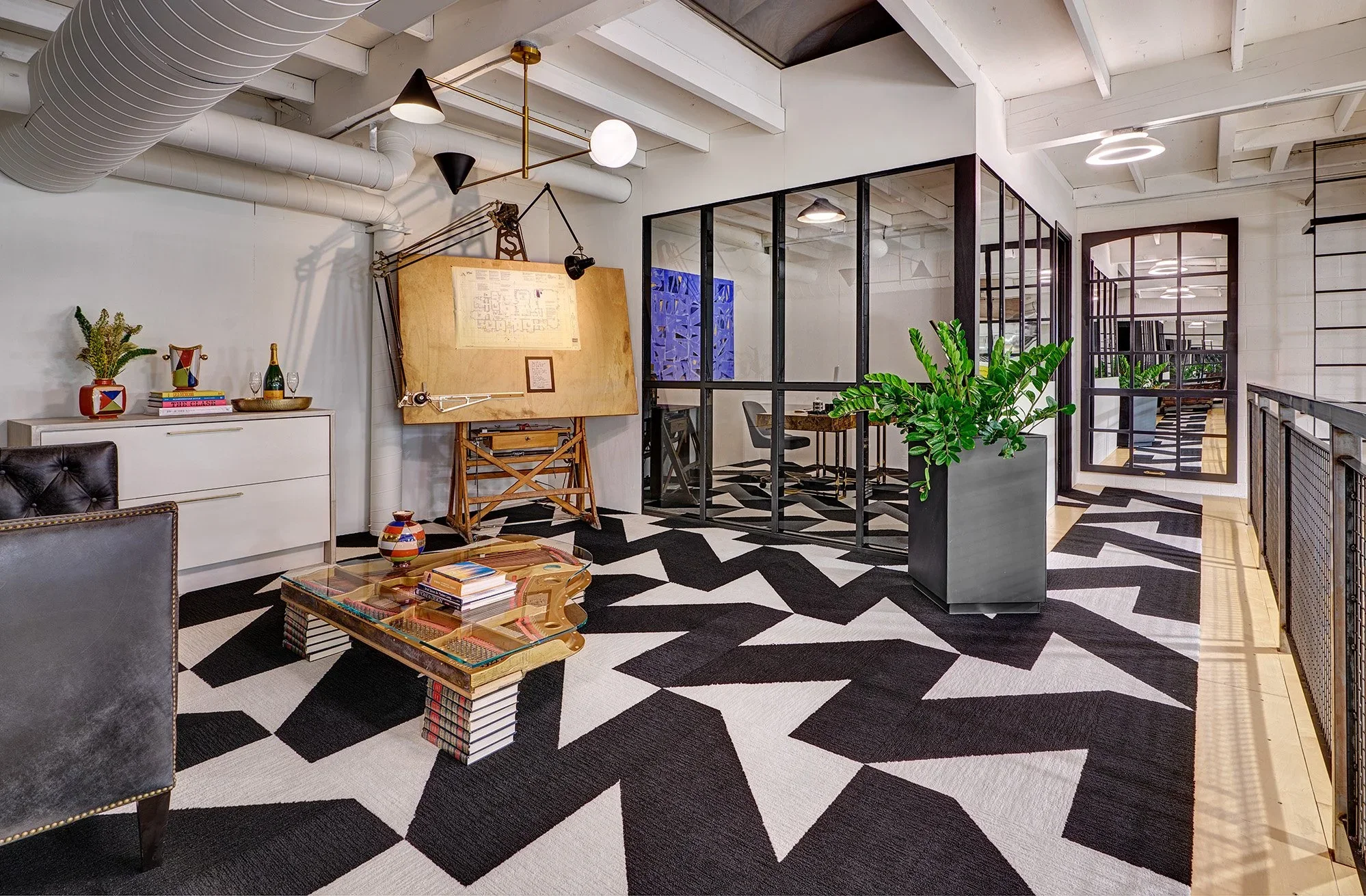 Mezzanine of interior design firm, black and white carpet, paneled refrigerator drawer, glass wall office
