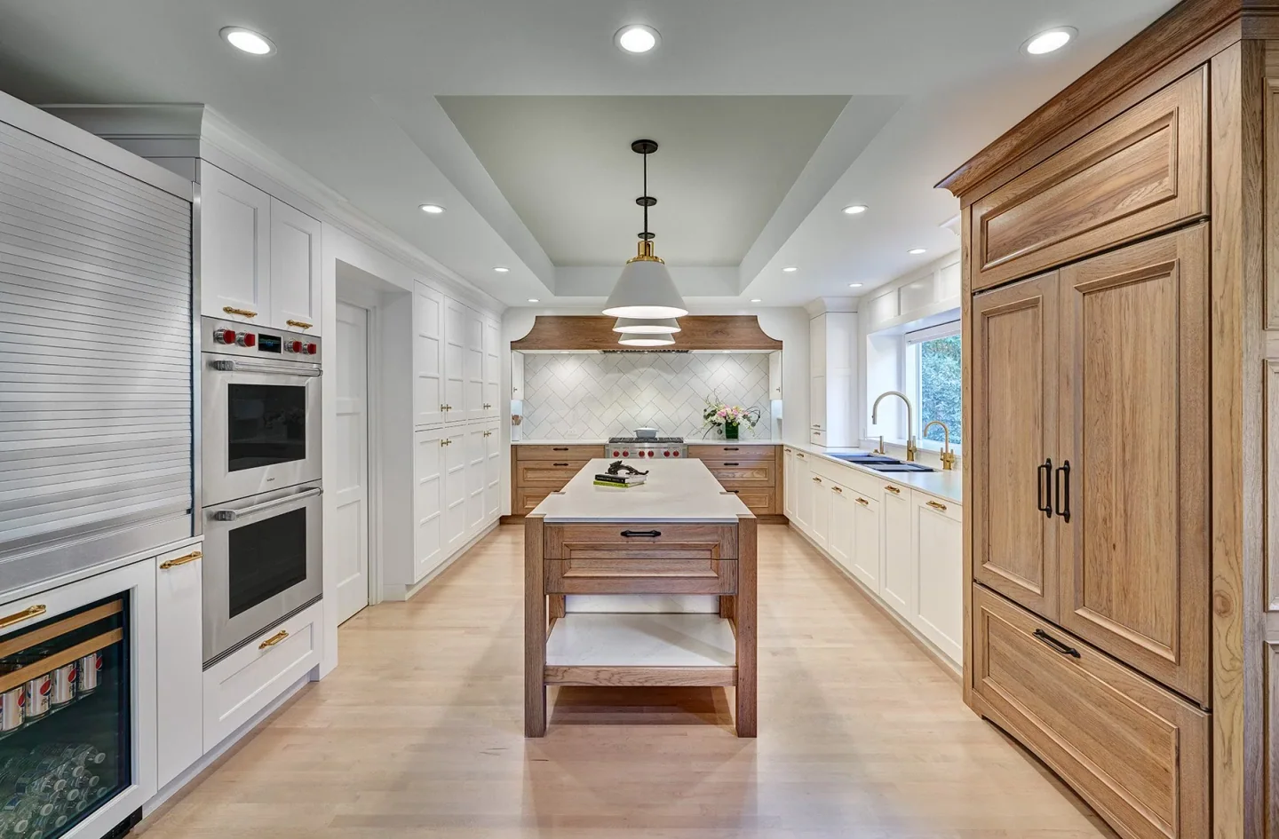 Hickory cabinetry and a white island in a warm, contemporary remodeled kitchen
