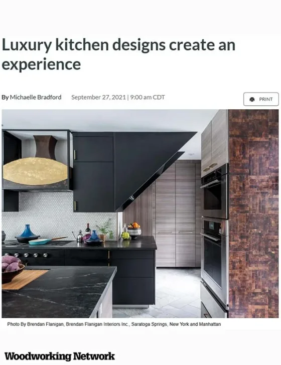 Modern black kitchen with a marble countertop, built-in ovens, and wood cabinetry, featuring dark walls and a unique angled ceiling design.