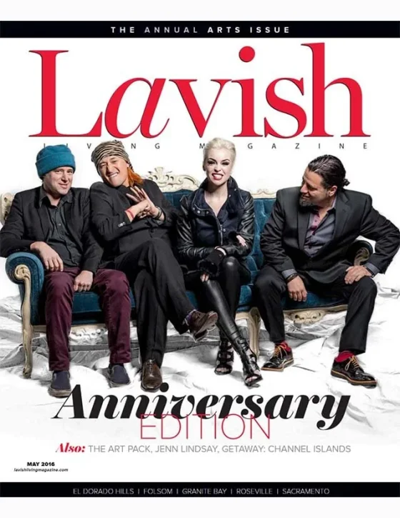 Cover of Lavish magazine's anniversary edition featuring four people sitting on a vintage-style sofa, smiling and posing for the camera, with the magazine title prominently displayed at the top.