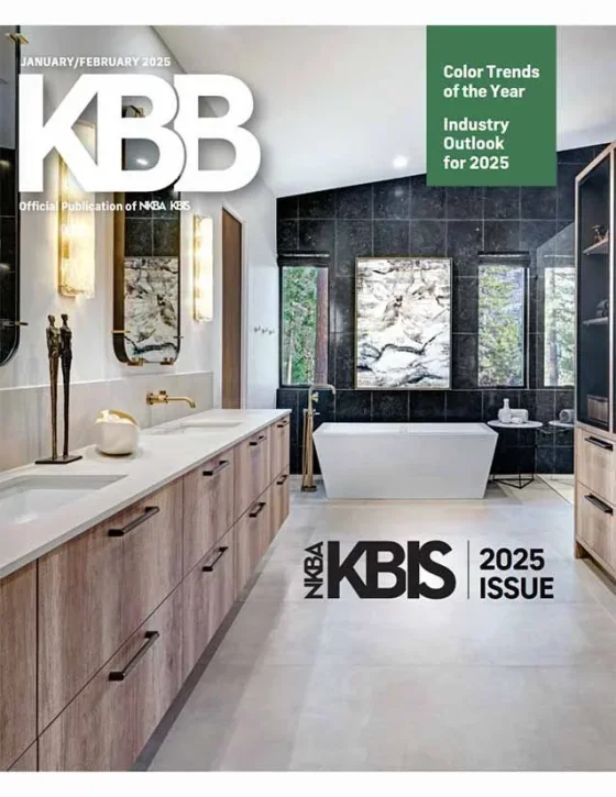 The cover of a magazine titled 'KBB', January/February 2025 issue, featuring a modern bathroom with a white bathtub, black tiled walls, a large mirror, wooden vanity, and decorative lighting.