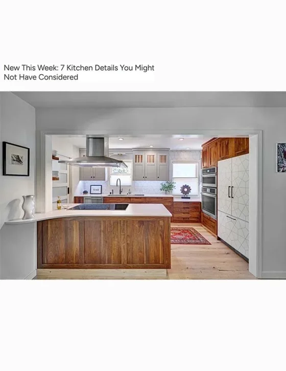 Modern kitchen with white and wooden cabinets, a kitchen island, stainless steel appliances, and a small window with a decorative rug on the floor.